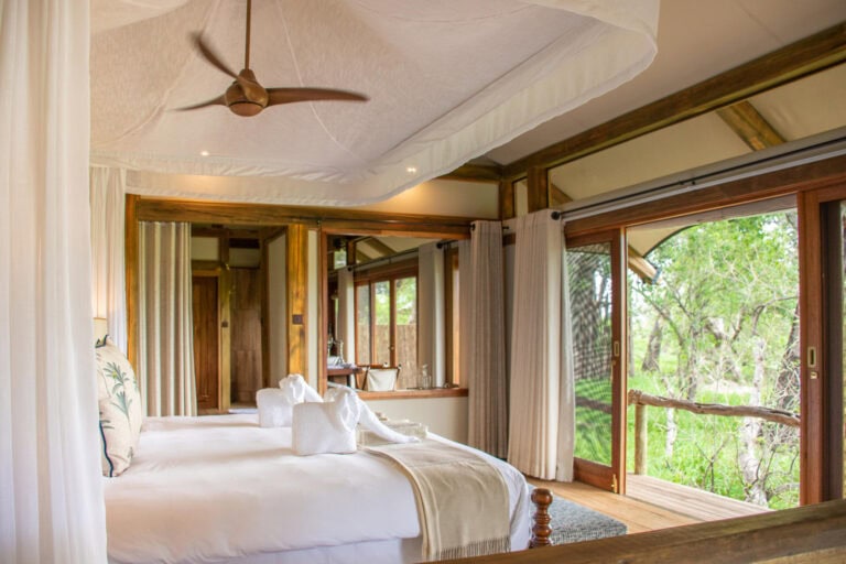 View of a luxury bedroom, overlooking the African bush at Kwara Camp, Botswana.
