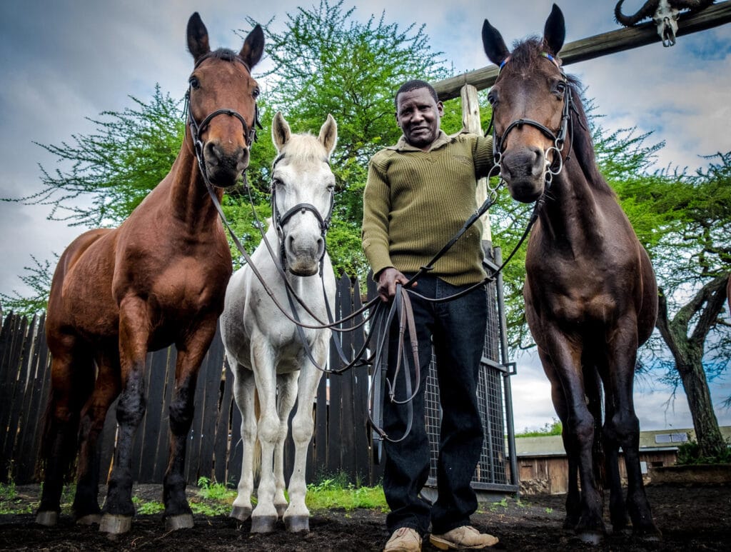 Guide preparing a few horses for a horseback safari | Photo credit: Ol Donyo Lodge