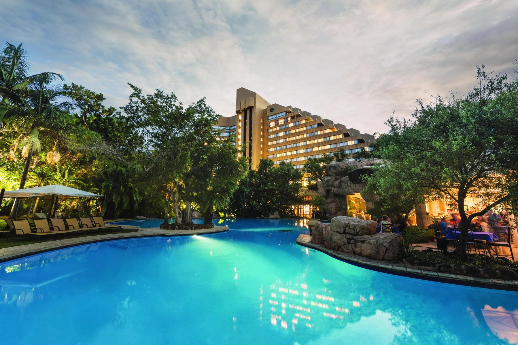 Exterior and pool of The Cascades Hotel in Sun City, a good place to stay on a solo holiday. 