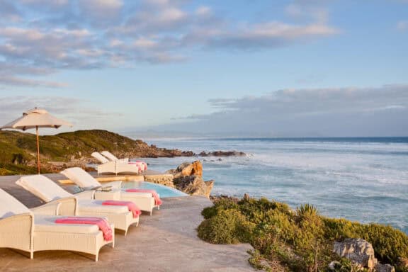 Loungers on the sun deck overlooking the ocean at Birkenhead House Hermanus