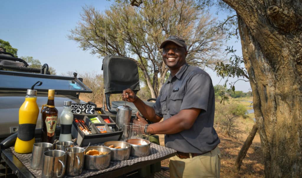 Safari guide making coffee in the wilderness