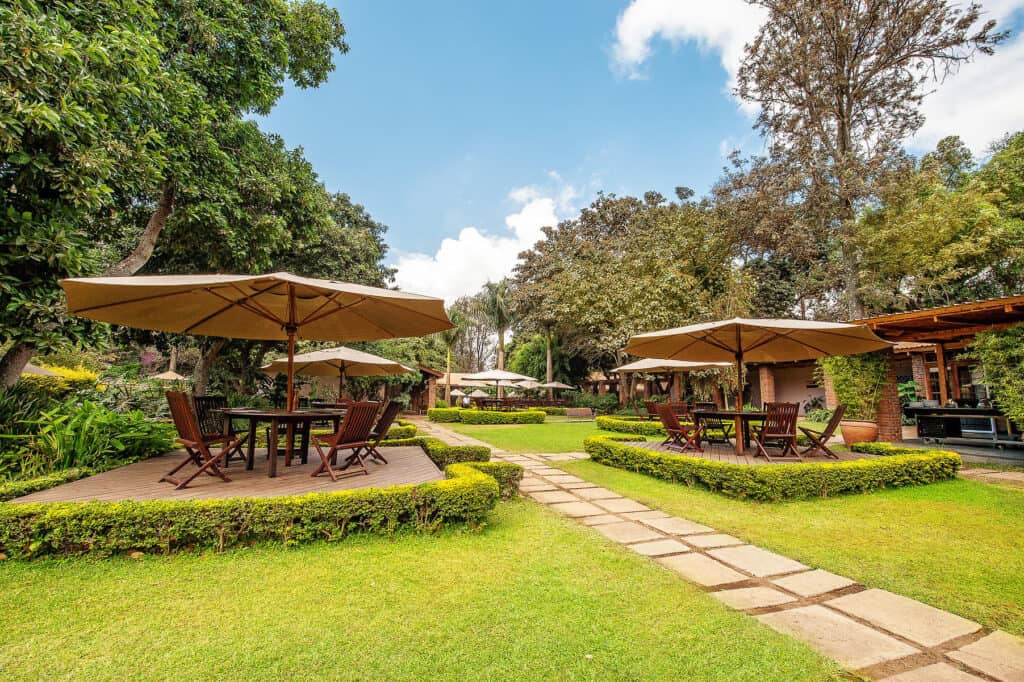 A shaded seating area at Arusha Coffee Lodge