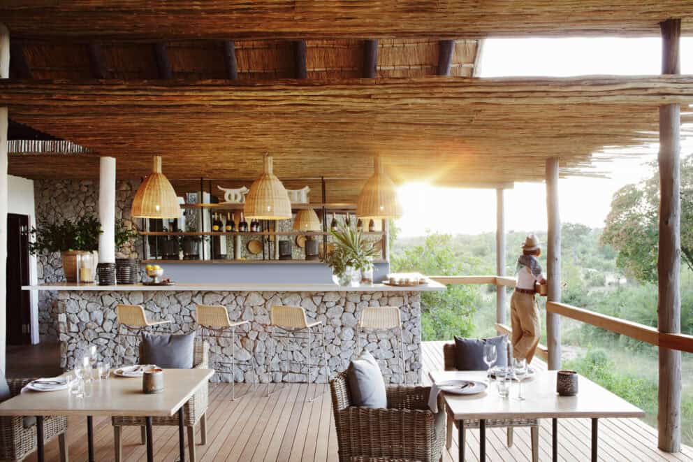 The opulent main area featuring a bar and deck at Londolozi Private Granite Suites, South Africa.