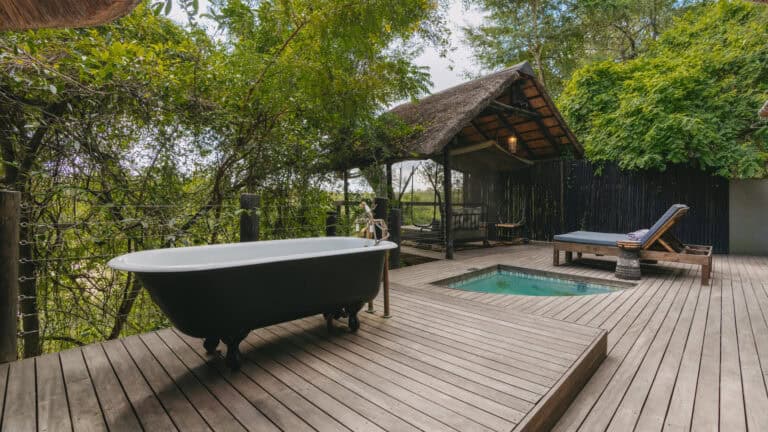Outside bath on the suite deck overlooking the plunge pool and landscape at Jock Safari Lodge, Southern Kruger