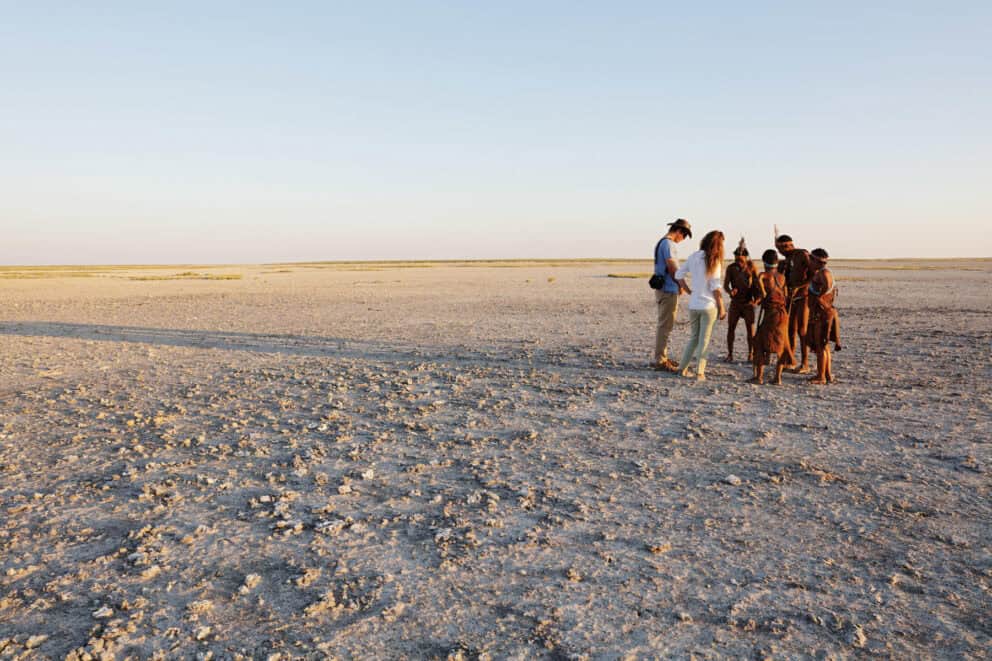 Tourist on a cultural tour with the San Bushmen in the Makgadikgadi Salt Pans at San Camp, Botswana.