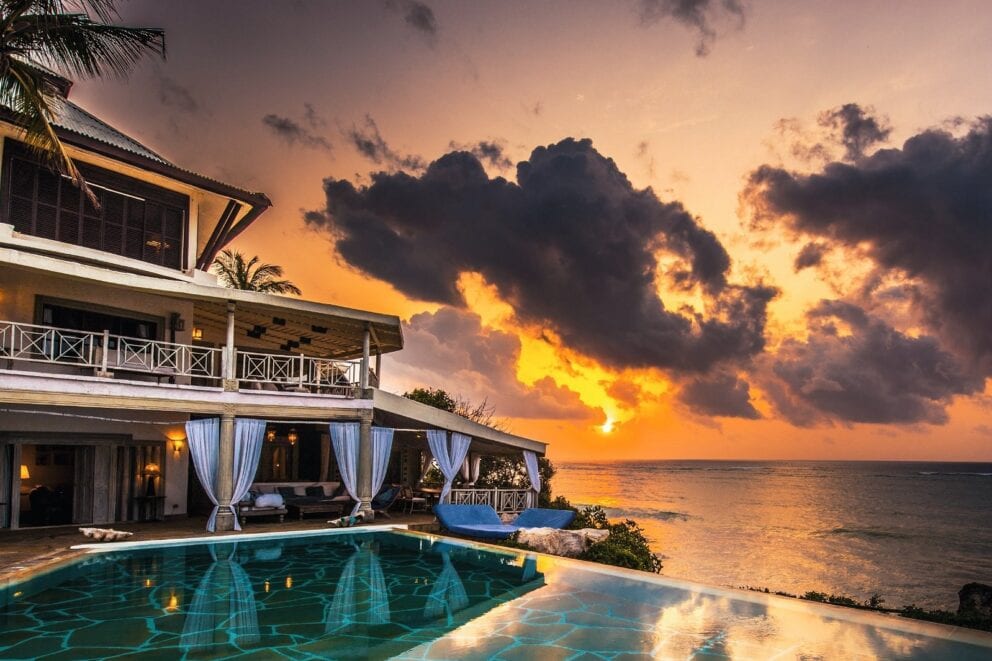 View of the lodge and Diani Beach at sunset at Alfajiri Villas, Kenya.