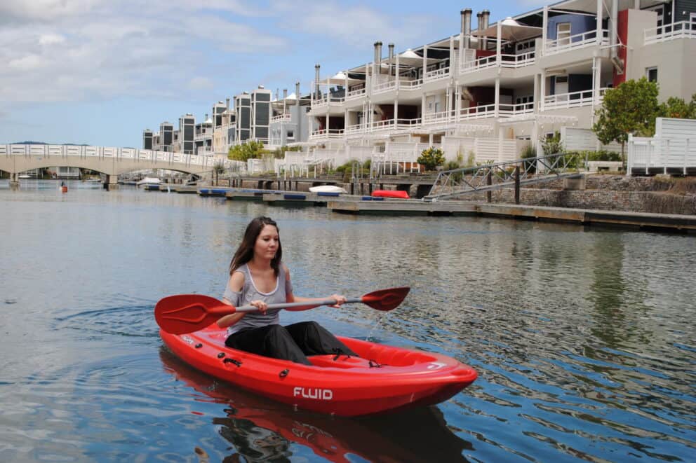 Woman kayaking on the Knysna Lagoon, South Africa.