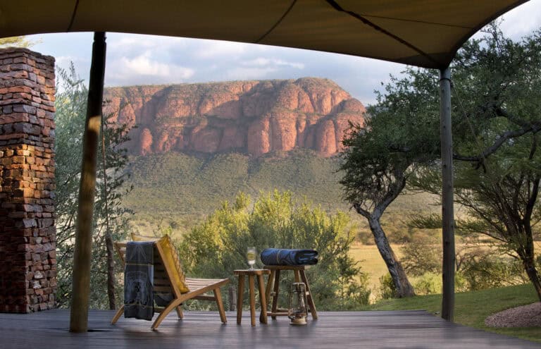 A private deck with a wooden comfy chair overlooking the Marakele National Park at Marataba Safari Lodge
