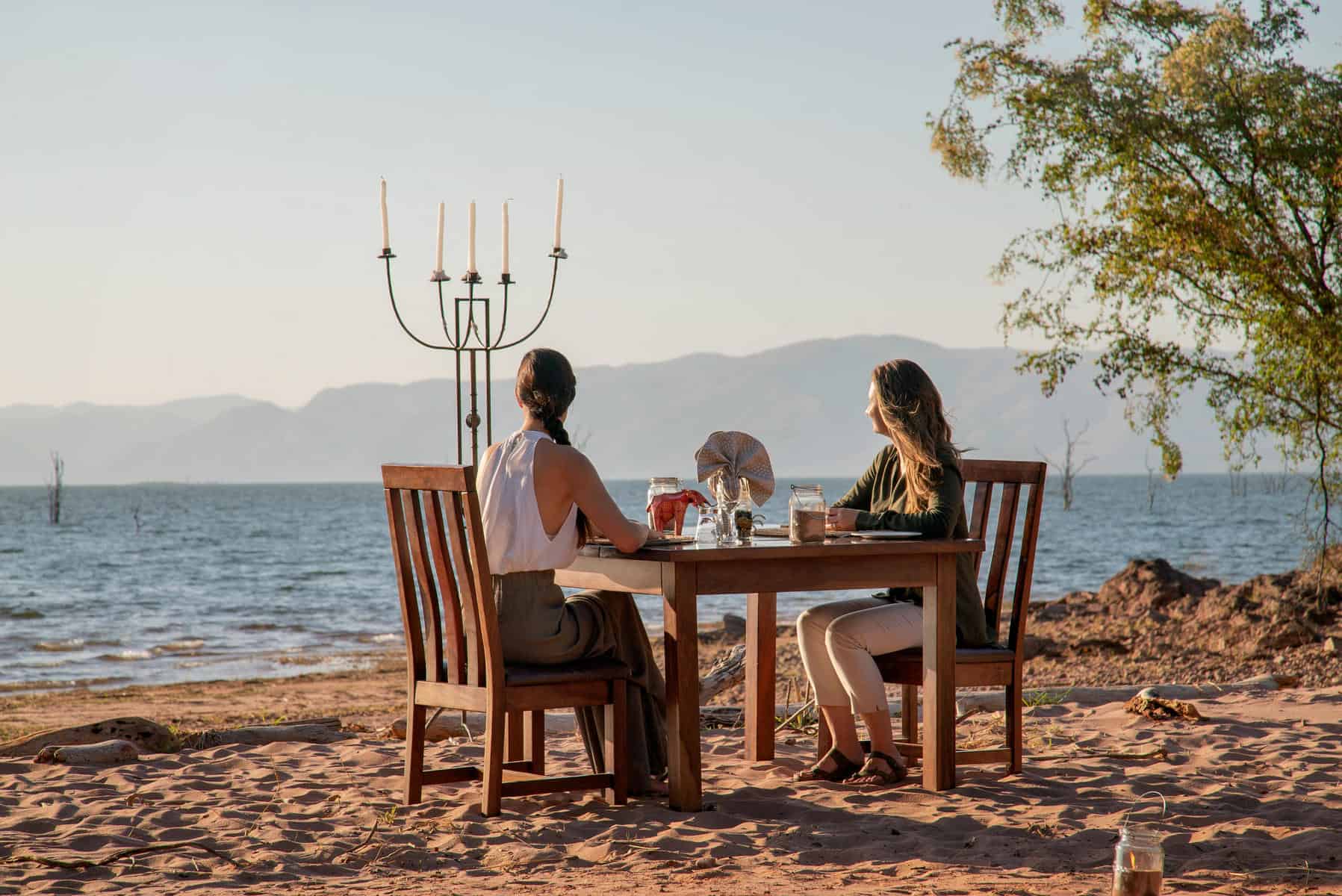 Women enjoying a meal on the shores of Lake Kariba