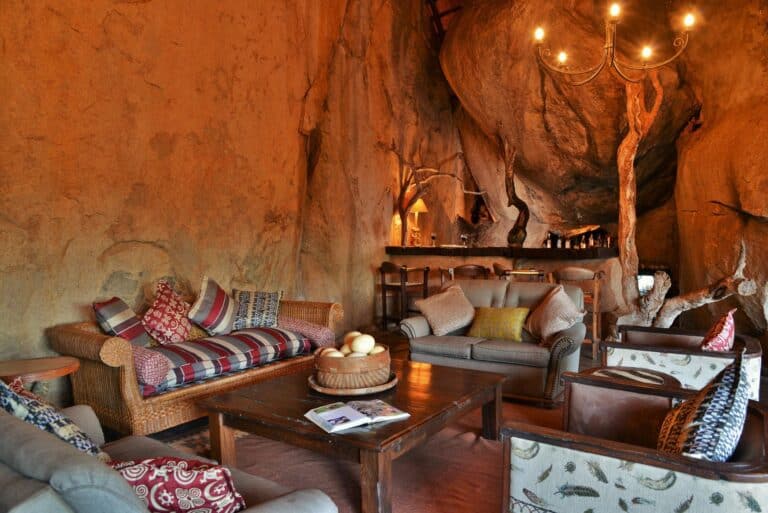 View of the upstairs lounge area with comfortable leather armchairs at Amalinda Lodge, Zimbabwe.