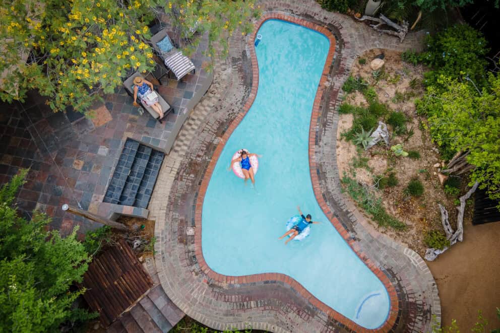 A family relaxing by the pool at Kambaku Safari Lodge, South Africa.