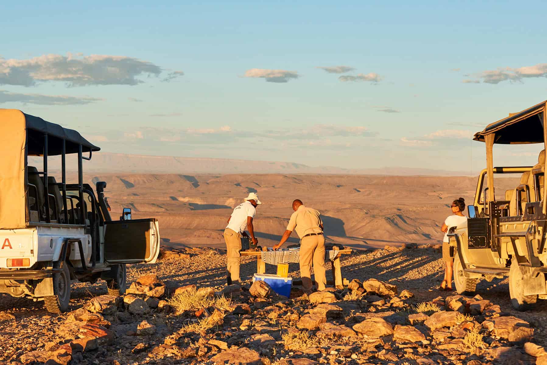 Guests enjoying sundowners overlooking Fish River Cayon, Namibia