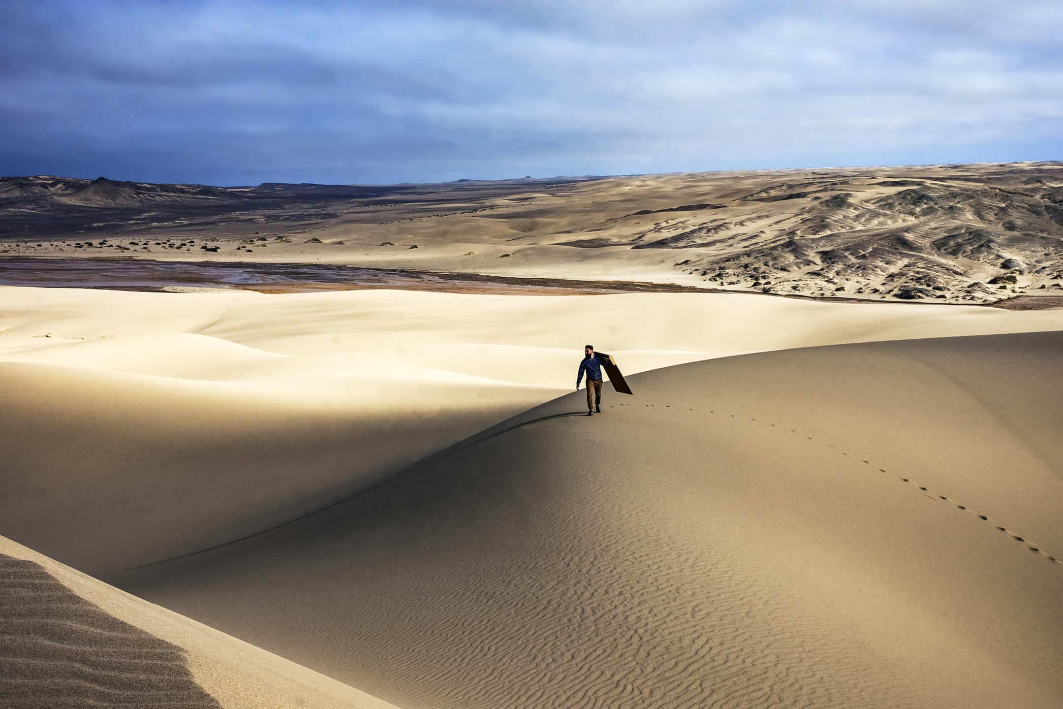 Sandboarding on the dunes of the Skeleton Coast, something Namibia is known for.
