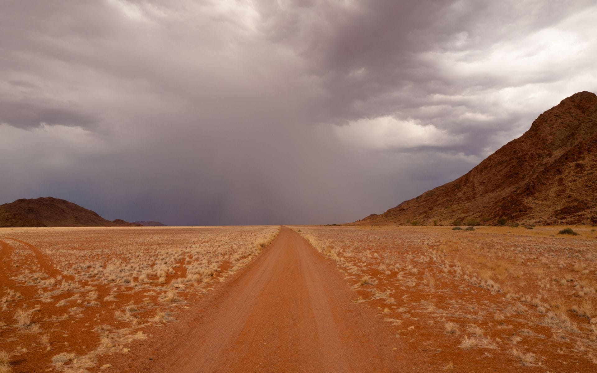 Grey clouds over a desert road in Namibia
