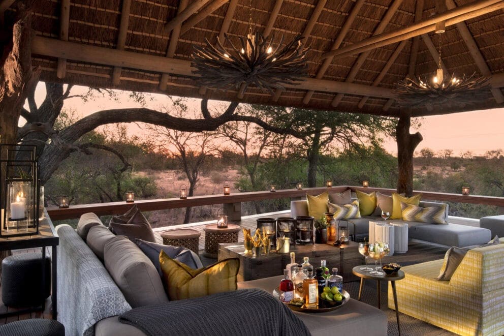Sundowners on the deck at Rockfig Safari Lodge with comfy seating and plush pillows.