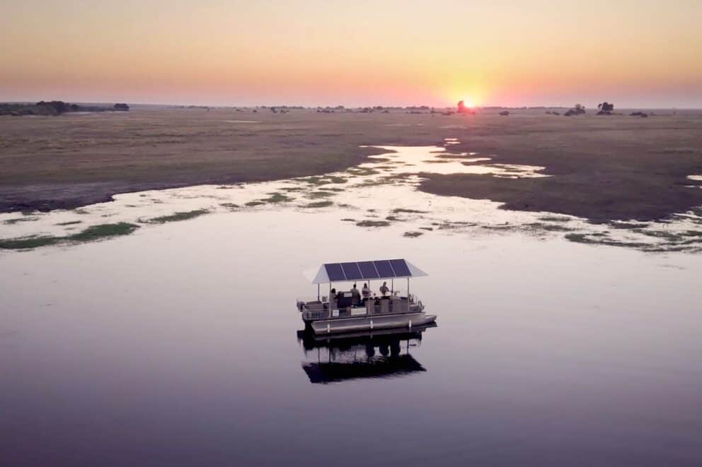 Guests on a sunset solar-powered boat cruise along the Chobe River near Chobe Game Lodge, Botswana.