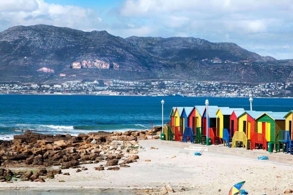 Surfer's Corner in Muizenberg with colourful beach huts in Cape Town, South Africa.