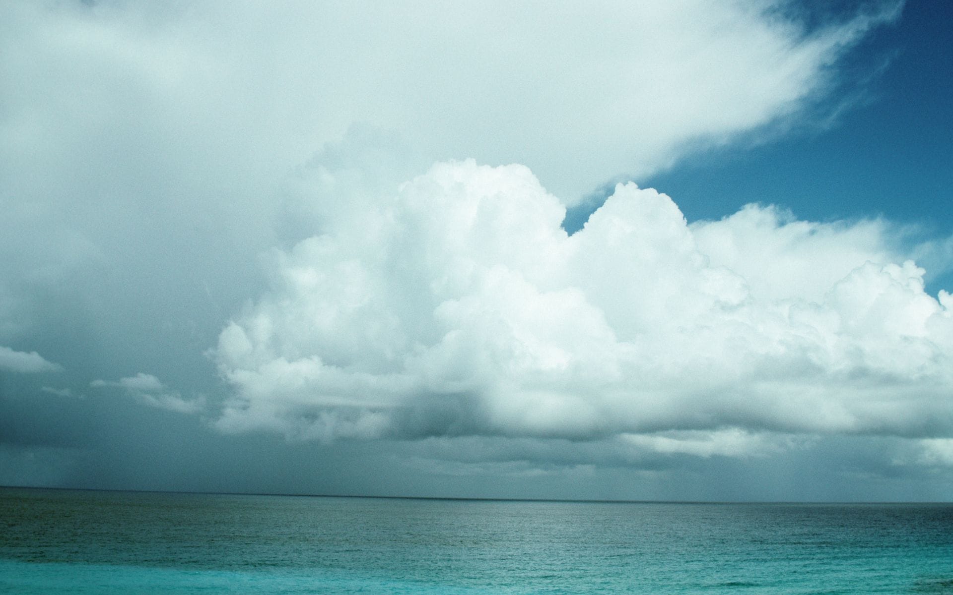 Ominous-looking clouds floating over the ocean signalling an impending storm.