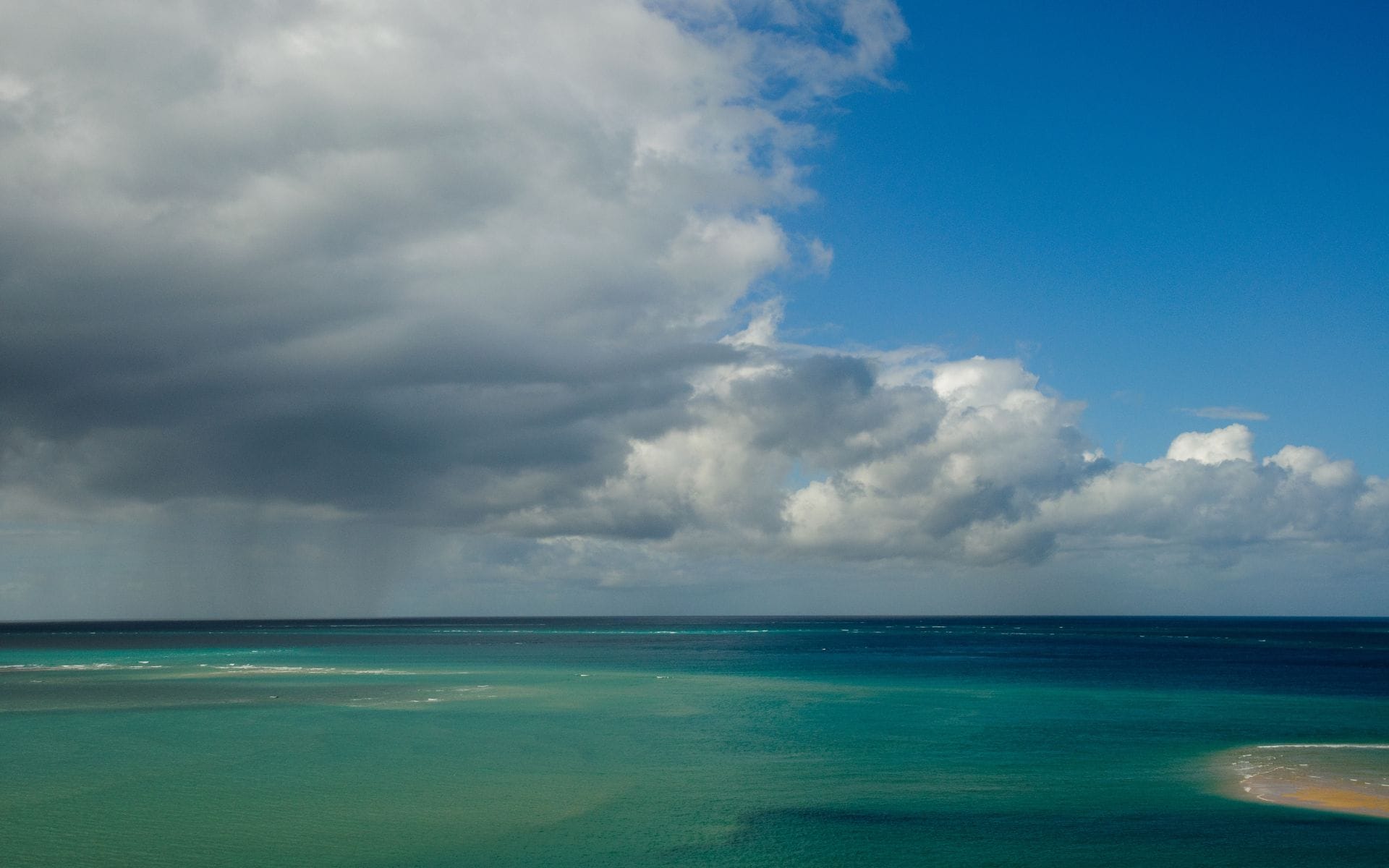 View of a rainstorm over a coastline in Mozambique near the Bazaruto Archipelago. 