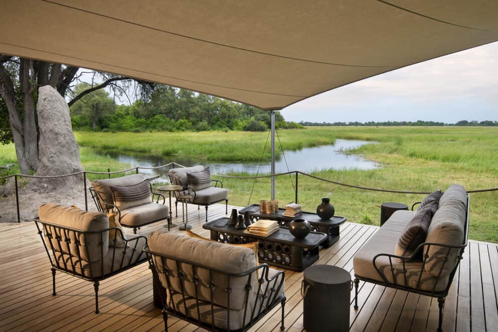 Lounge on the deck overlooking a winding river and bush at Khwai Leadwood, Botswana