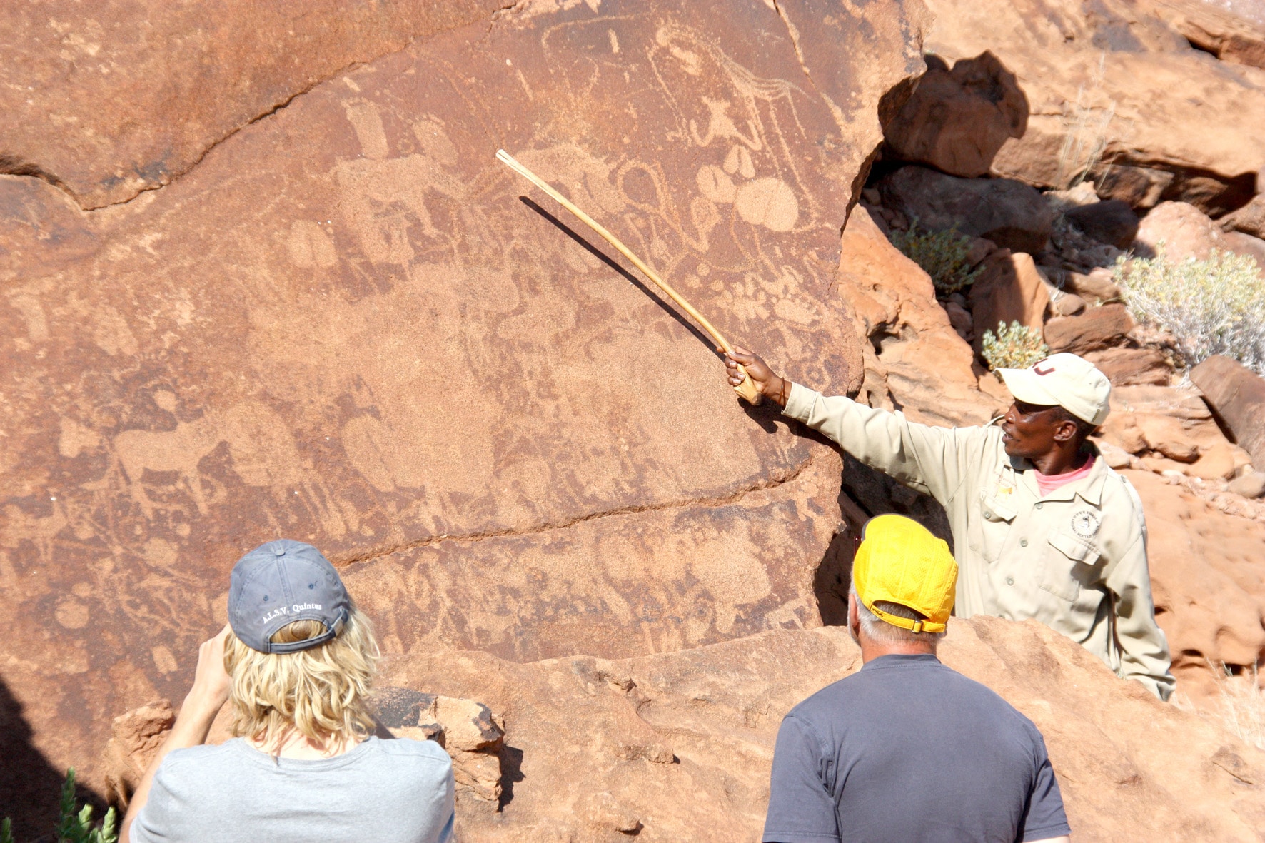 Guide explaining the San rock art at Twyfelfontein, Namibia