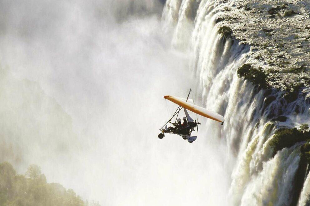 Microlight flies above Victoria Falls.