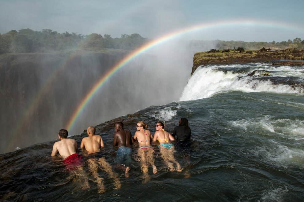 Tourists on the edge of Devil's Pools in Victoria Falls.