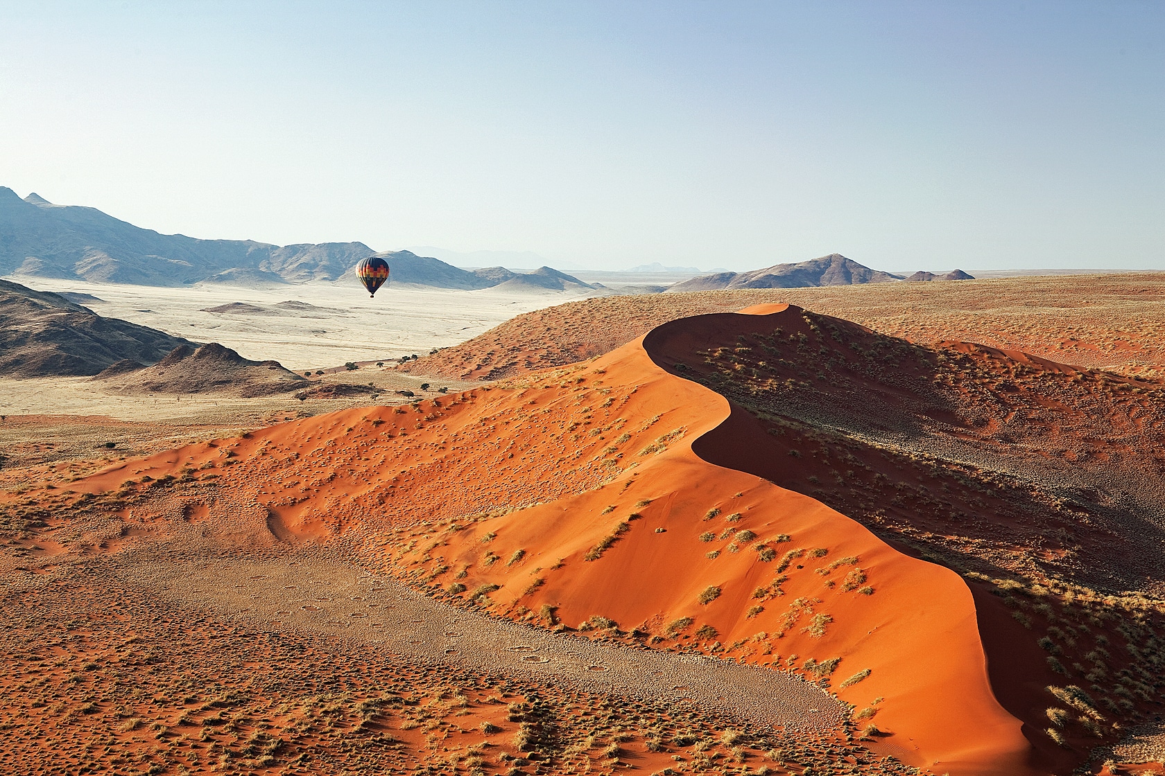 Hot air balloon flying over the Namib Desert at Kulala desert lodge, Namibia.