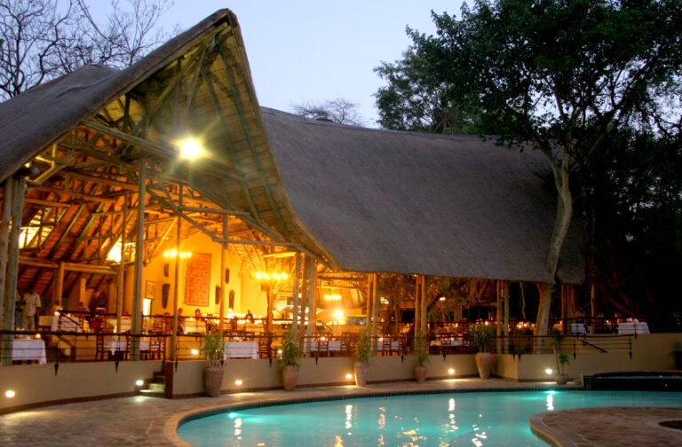 View of the lodge from the pool deck at sunset at Chobe Safari Lodge, Botswana.
