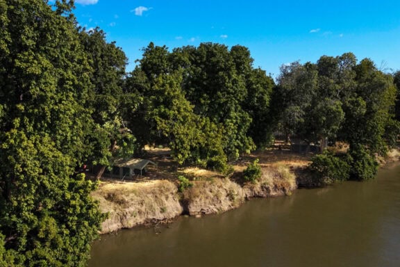 Mana River Camp - Tent on River bank, Image credit, Mana River Camp