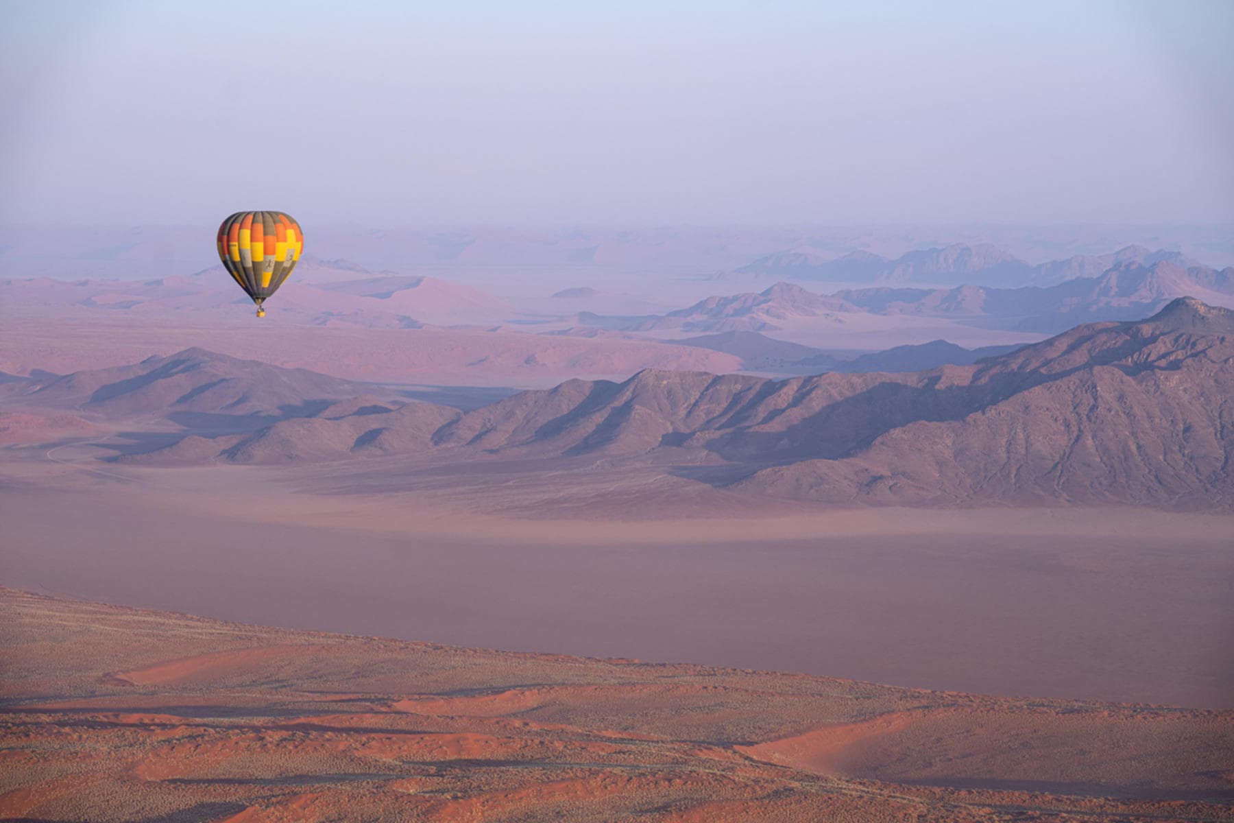 Hot air balloon flying over the NamibRand Nature Reserve, Namibia at Kwessi Dunes.