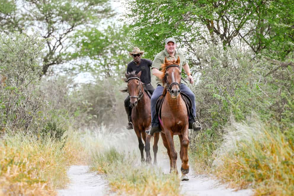 Guests on a guided horse-riding safari at Feline Fields Lodge, Botswana.