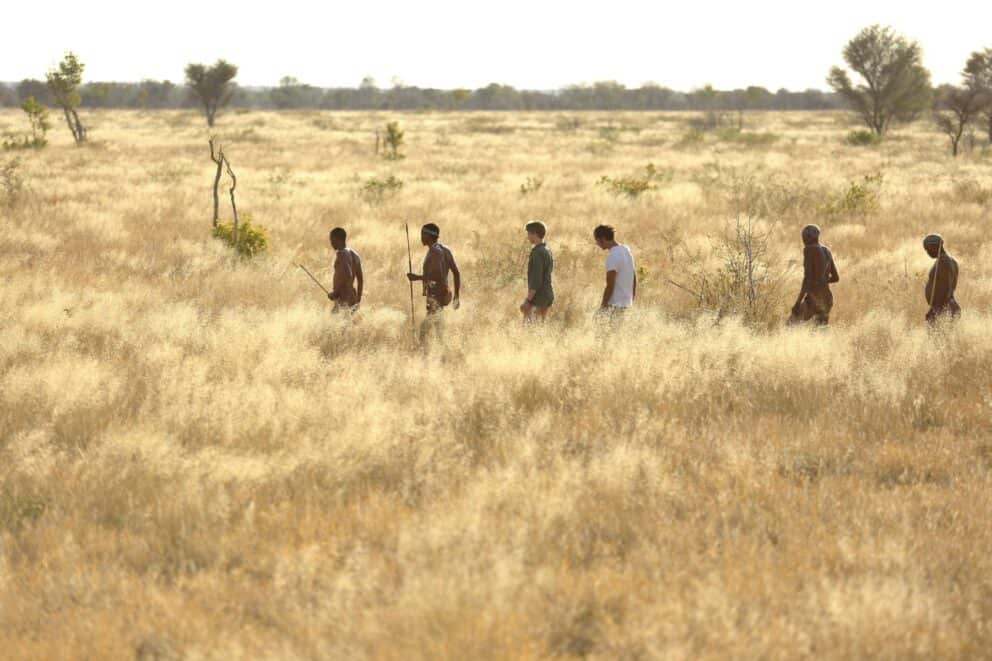Guests on a guided bushmen walk in the Kalahari near Feline Fields Lodge, Botswana.
