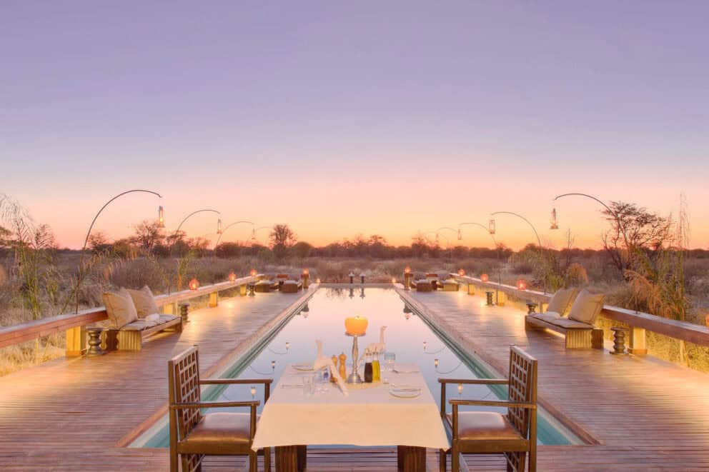 Sunset romantic dinner with poolside table | Photo credit: Feline Fields Lodge