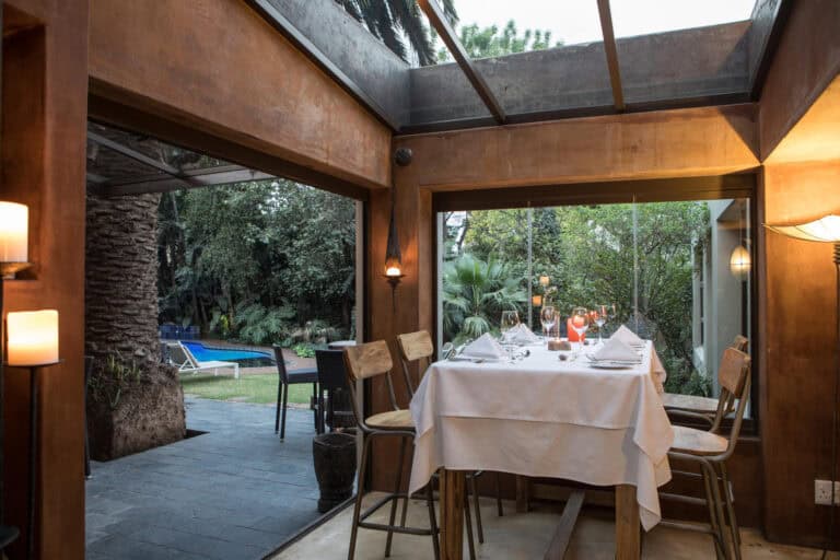 Dining area overlooking the outdoors and pool at African Rock Hotel & Spa, South Africa.