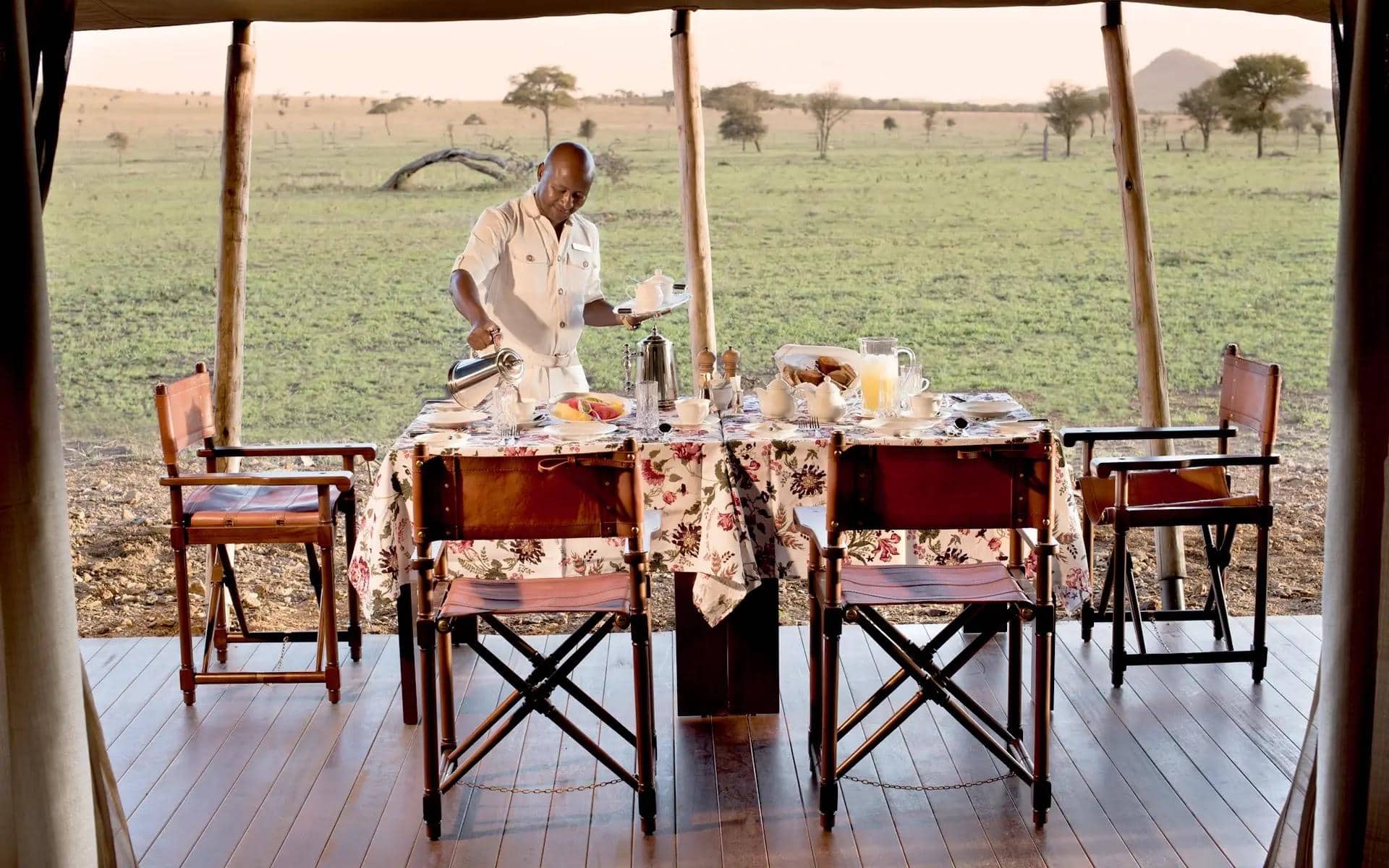 Family luxury tent verandah with dinner table with a view | Photo credit: One Nature Nyaruswiga