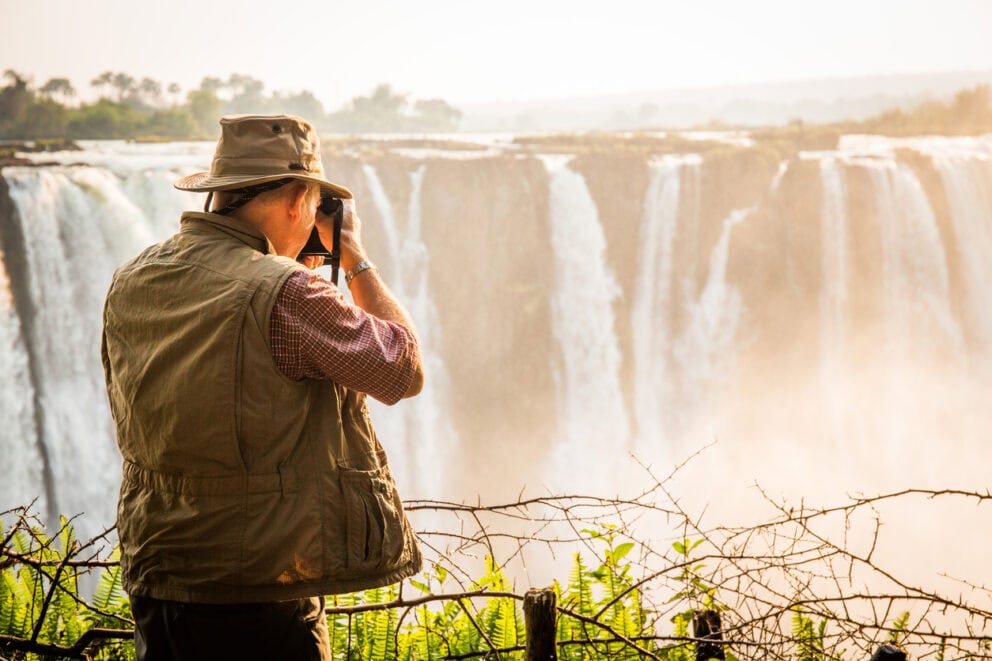 Man capturing the beauty of Victoria Falls, Zimbabwe. Photo: Getty Images