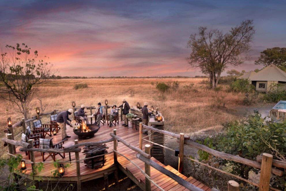 View of a outdoor fireplace and seating area on a deck 