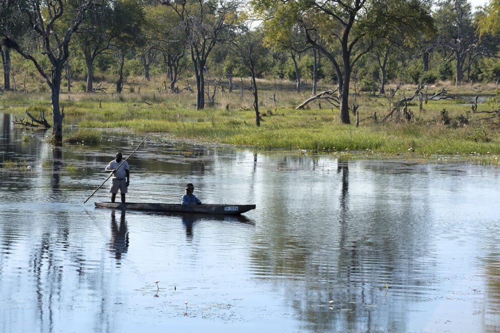 Two people in a canoe in the Okavango Delta in Botswana