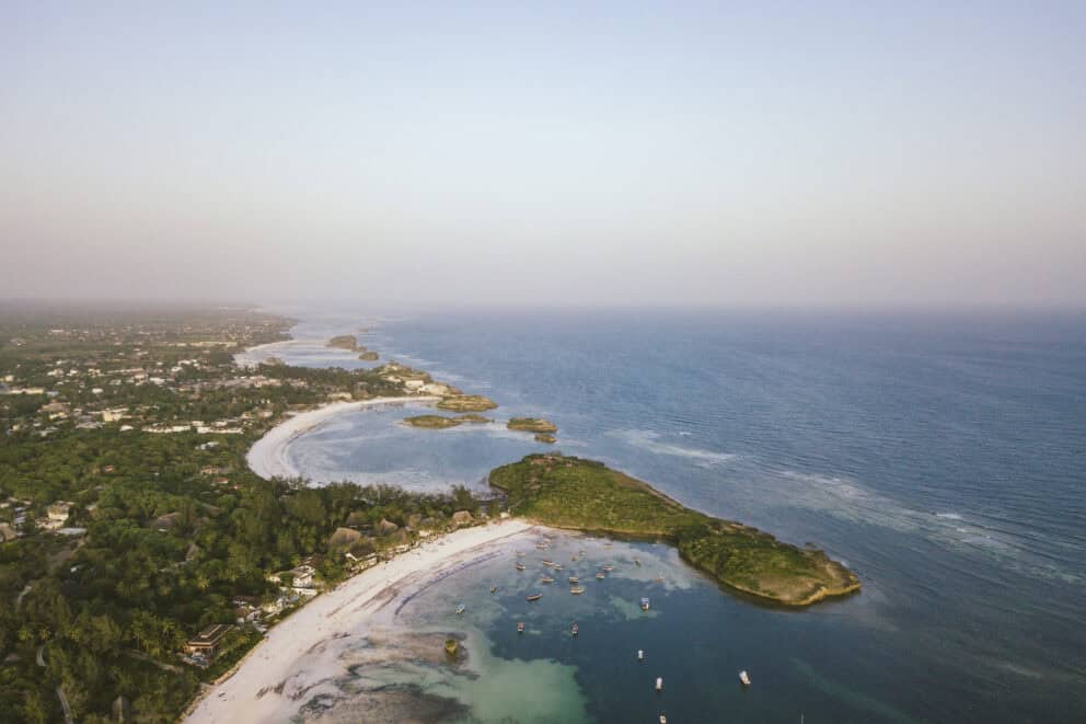 Aerial view of Watamu Beach, Kenya with anchored boats, sandy beaches and lush forest hugging the coast.