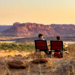 Couple having sundowners at Twyfelfontein Adventure Camp