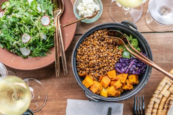 A table set with various food and white wine