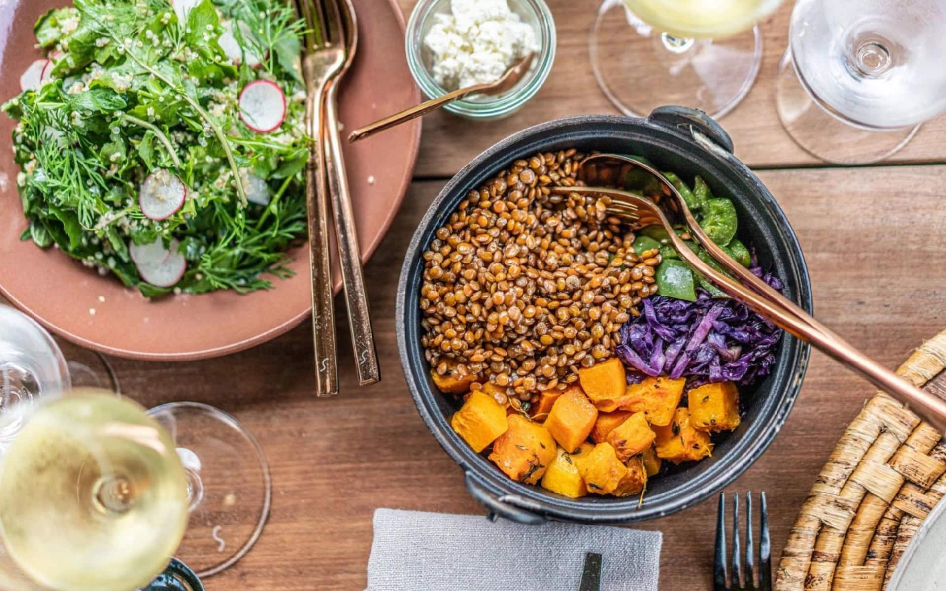 A table set with various food and white wine