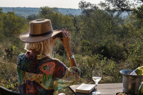 Viewing wildlife through binoculars | Photo credit: Geiger's Camp