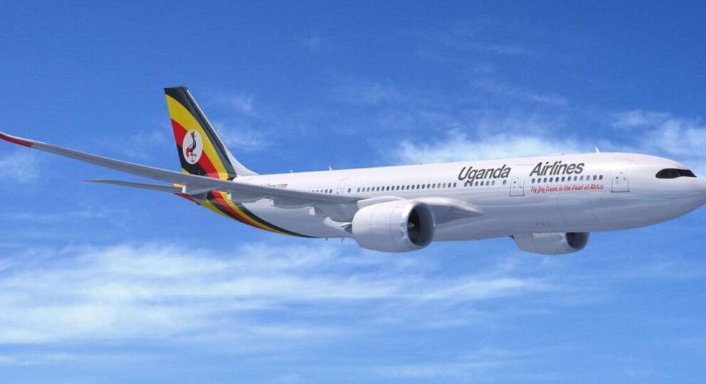 Uganda Airlines plane flying across blue sky