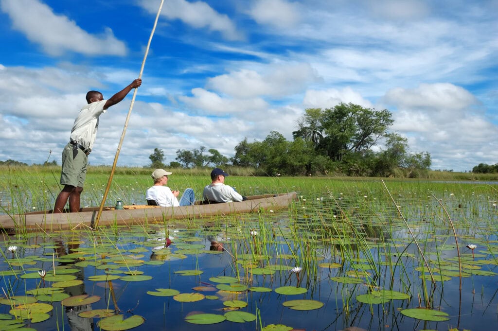Two travellers on a mokoro safari in the Okavango Delta, Botswana
