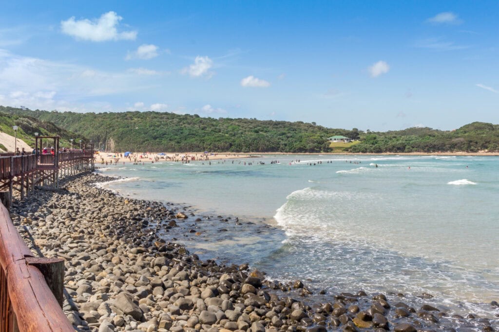 Boardwalk and beach with tide coming in on a hot summer's day along the Wild Coast