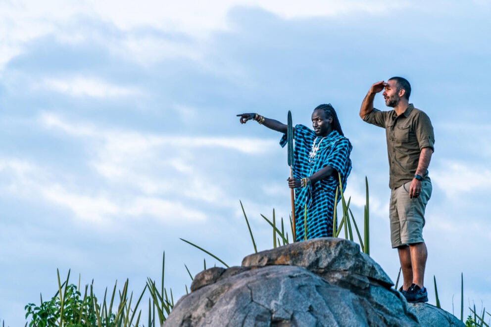 A traveller on a Massai guided nature walk near Lemala Osonjoi Lodge on the Ngorongoro Crater Rim, Tanzania.
