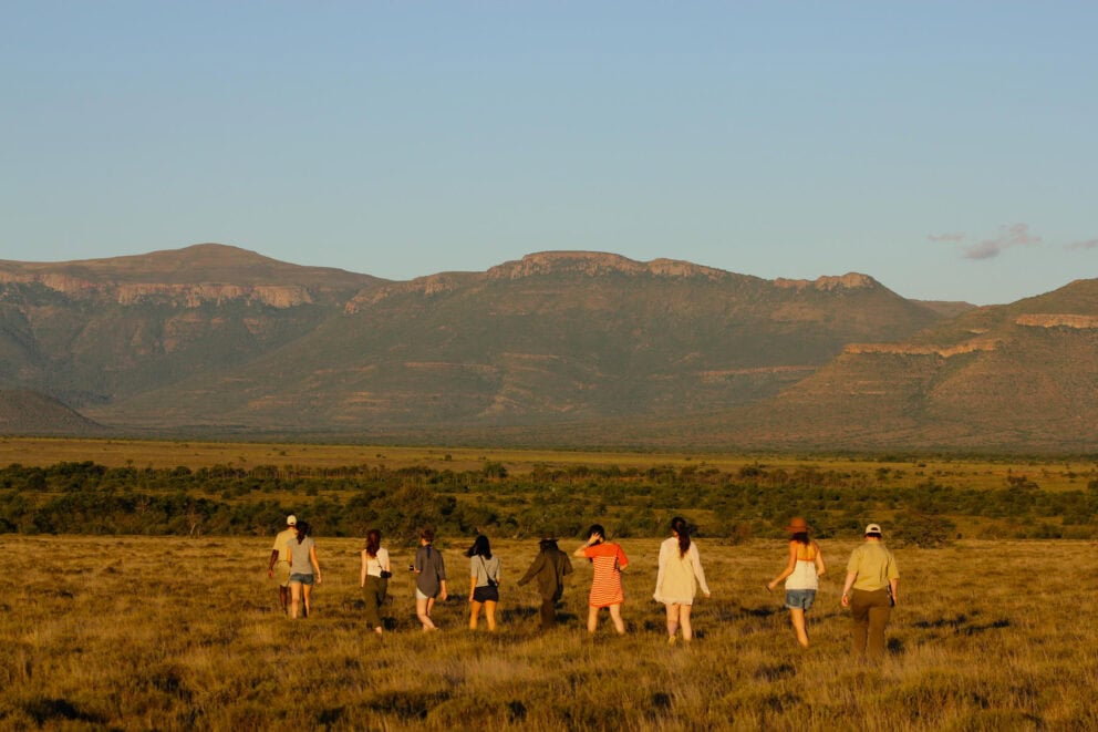 Tourists on a guided walking safari at Karoo Lodge at Samara, South Africa.