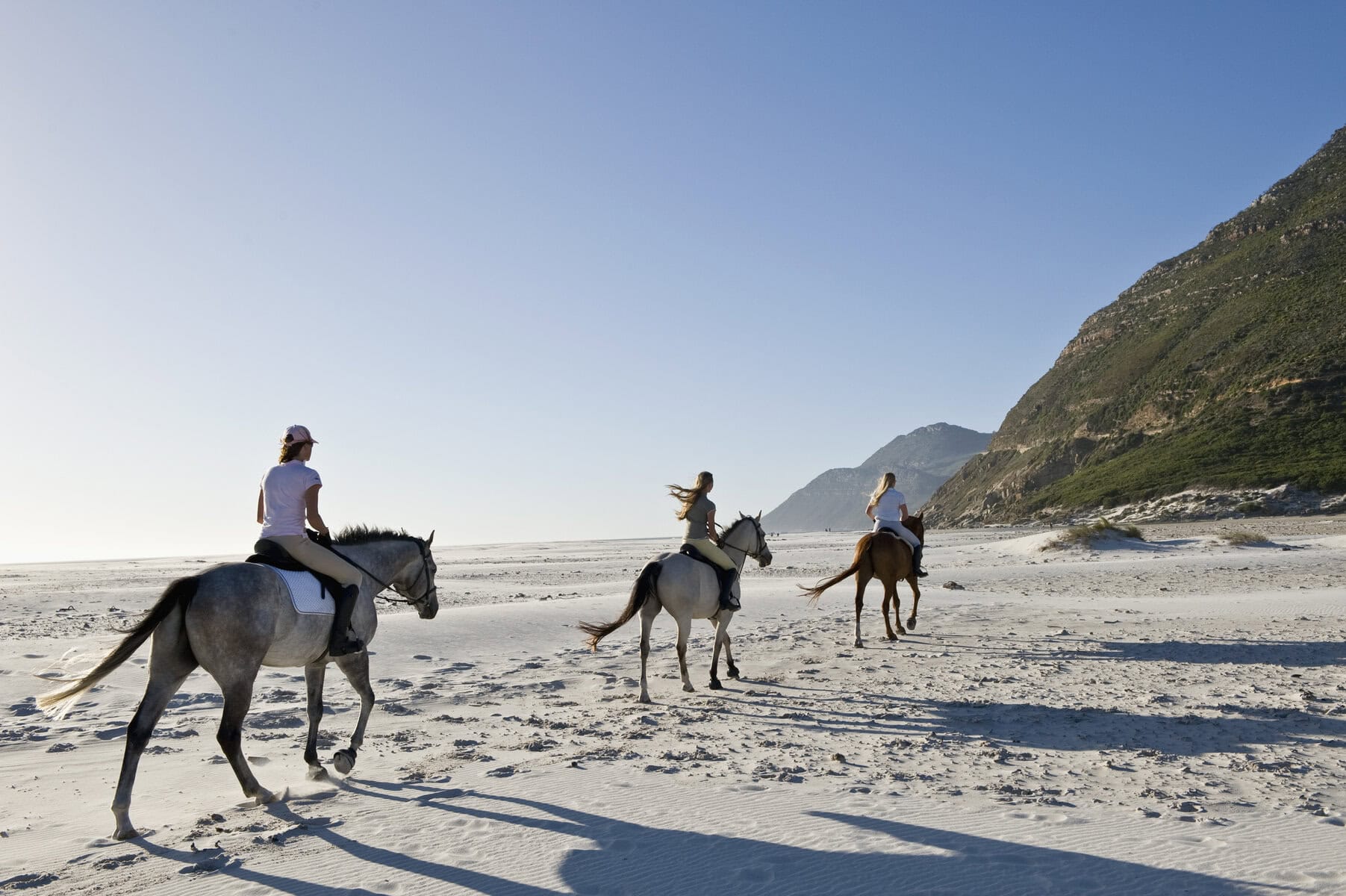 Three people on a horseriding safari in South Africa
